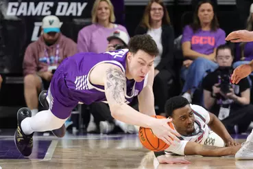 image » Greenville Sports Media GCU Big man diving on the floor exerting his power to secure a steal.