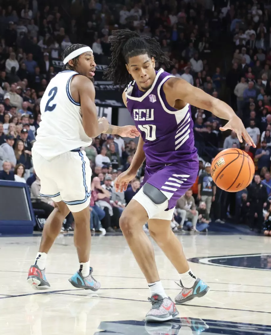 image » Greenville Sports Media GCU #10 Jaden Henley with a behind the back dribble to which resulted in a spin cycle dunk on USU #2 MJ Collins