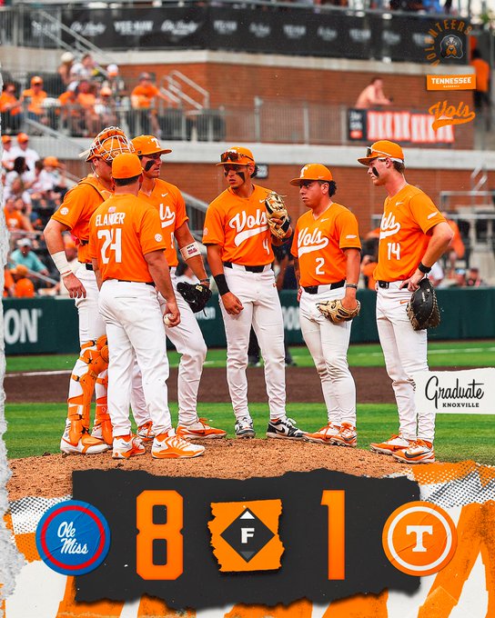 Tennessee Volunteers players in orange uniforms huddle on the pitcher’s mound during a game; scoreboard shows 8–1 with team logos.