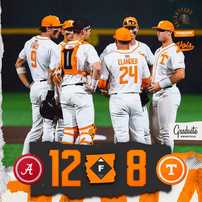 Tennessee Volunteers baseball players huddle on the field, score 12–8 on a torn banner; Alabama and Tennessee logos visible, Gradate Knoxville sign in foreground.