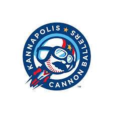 Logo of the Kannapolis Cannon Ballers baseball team, featuring a shark wearing a helmet inside a blue circular badge.