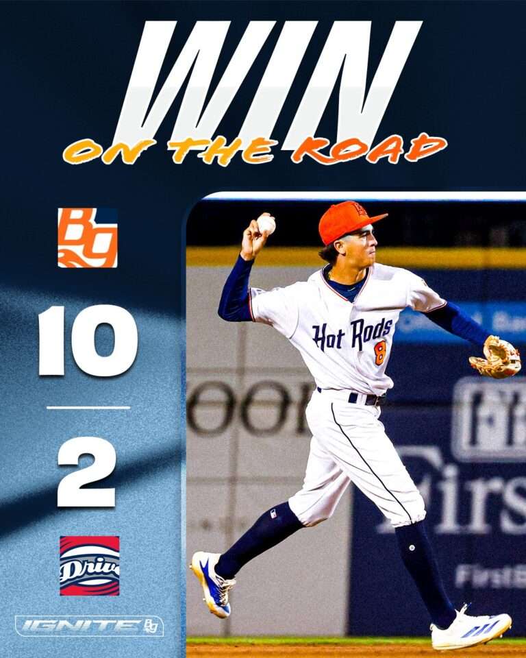 Poster-style image of a baseball pitcher in a white Hot Rods uniform throwing a pitch, with 'WIN ON THE ROAD' title and a vertical 10–2 score on the left.