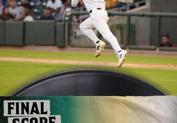 Baseball player in white, mid-air, celebrating near the final score banner reading 4–3.