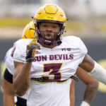 Sun Devils football player, number 3, in a white jersey with yellow helmet, running on the field during a game.