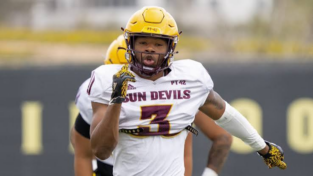 Sun Devils football player, number 3, in a white jersey with yellow helmet, running on the field during a game.