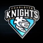 Charlotte Knights team logo featuring a knight's helmet on a blue shield against a dark background.