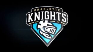 Charlotte Knights team logo featuring a knight's helmet on a blue shield against a dark background.
