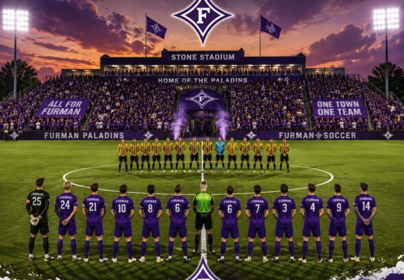 Furman Paladins men's soccer team lined up on the field at Stone Stadium at sunset, in purple uniforms amid a large crowd.