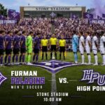 Furman Paladins vs. High Point men’s soccer teams line up on the field at Stone Stadium as fans watch in purple.