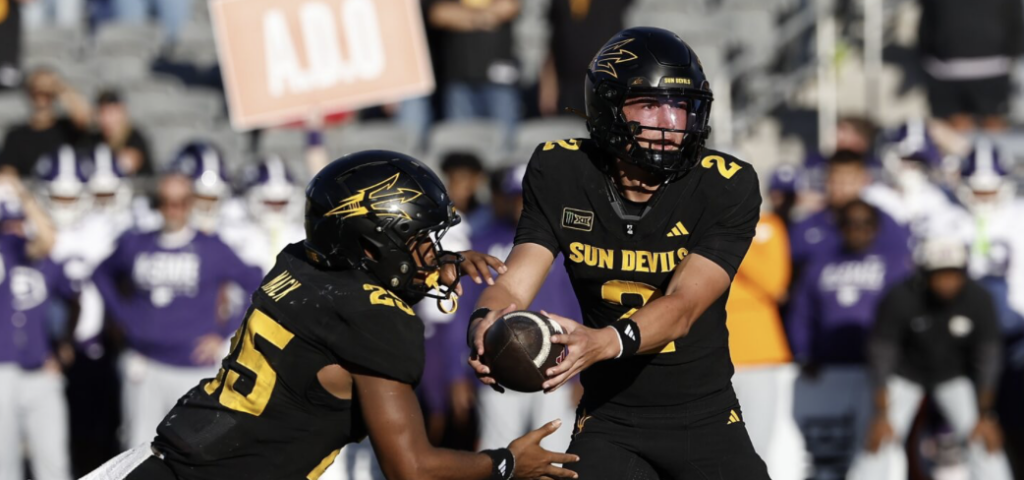 ASU Freshman Standout Jake Fette hands the ball off the Cardae Mack.